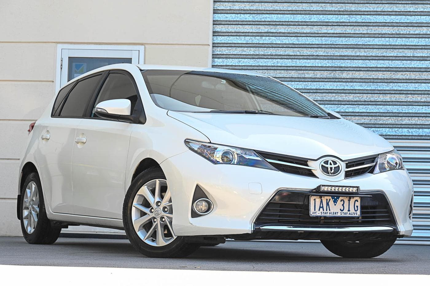 2013 Toyota Corolla Ascent Sport in white — front three-quarter view at the Ripper Cars showroom in Springvale
