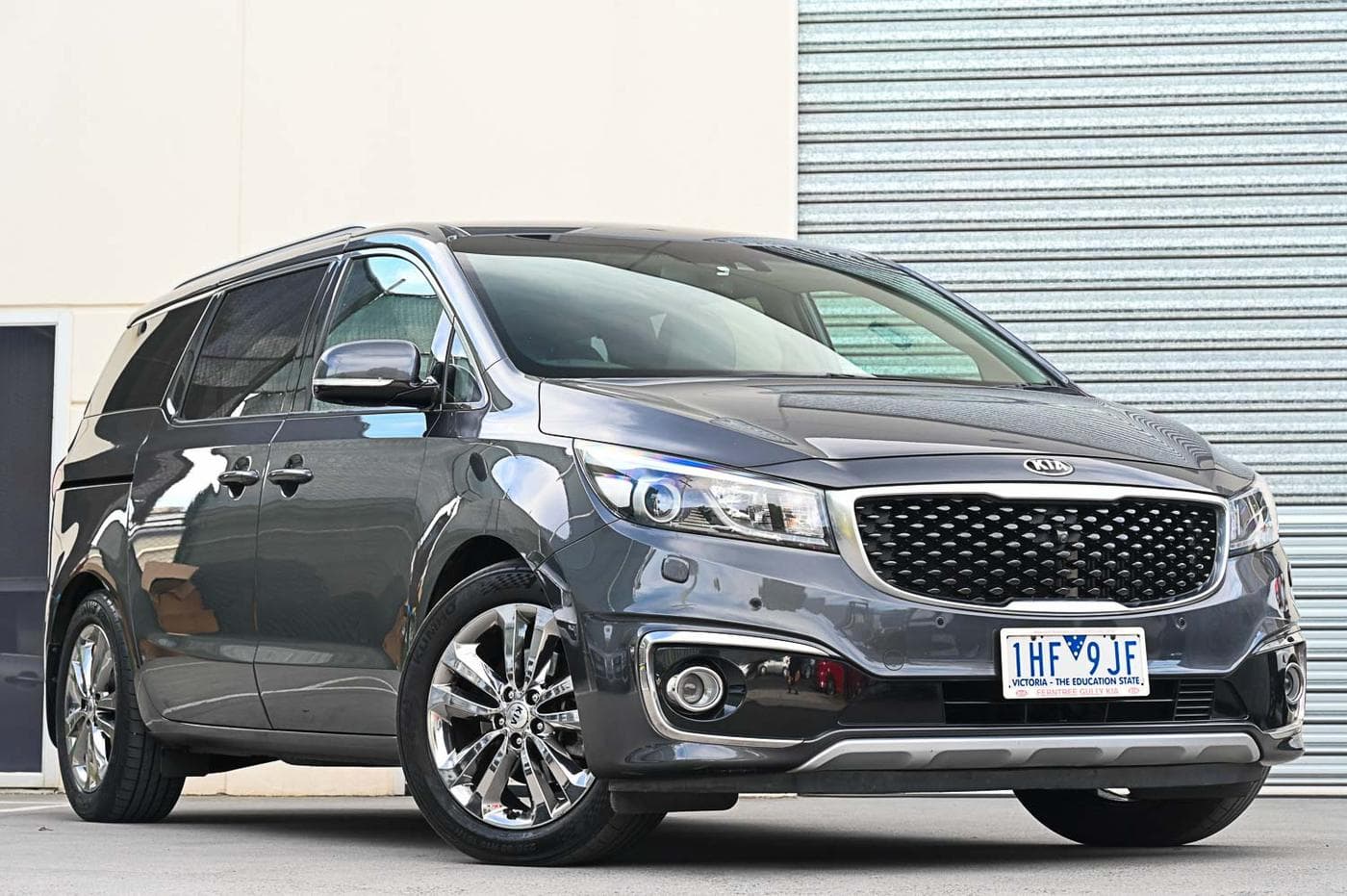 2016 Kia Carnival Platinum CRDi in charcoal — front three-quarter view at the Ripper Cars showroom in Springvale