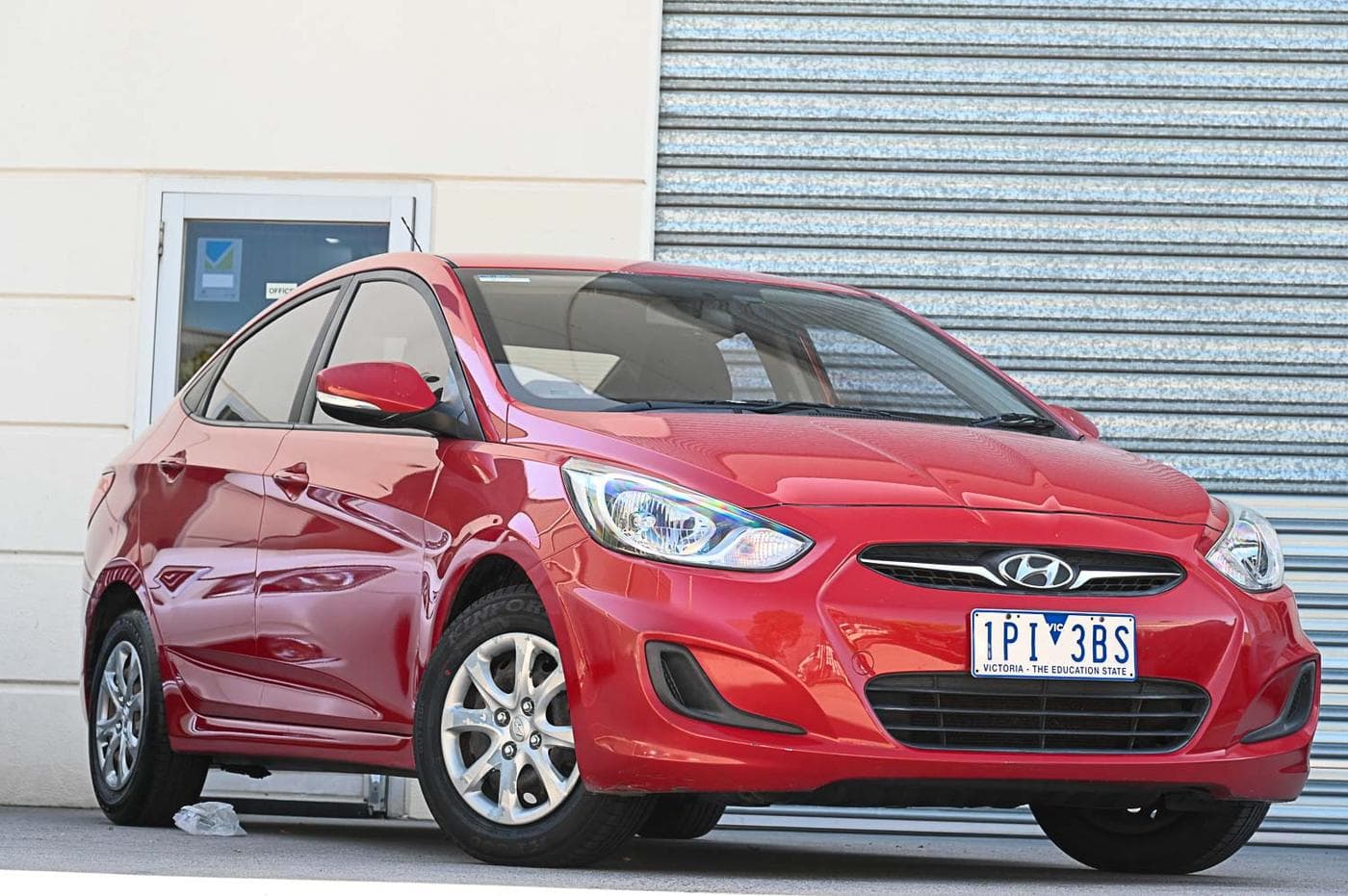 2014 Hyundai Accent Active in red — front three-quarter view at the Ripper Cars showroom in Springvale