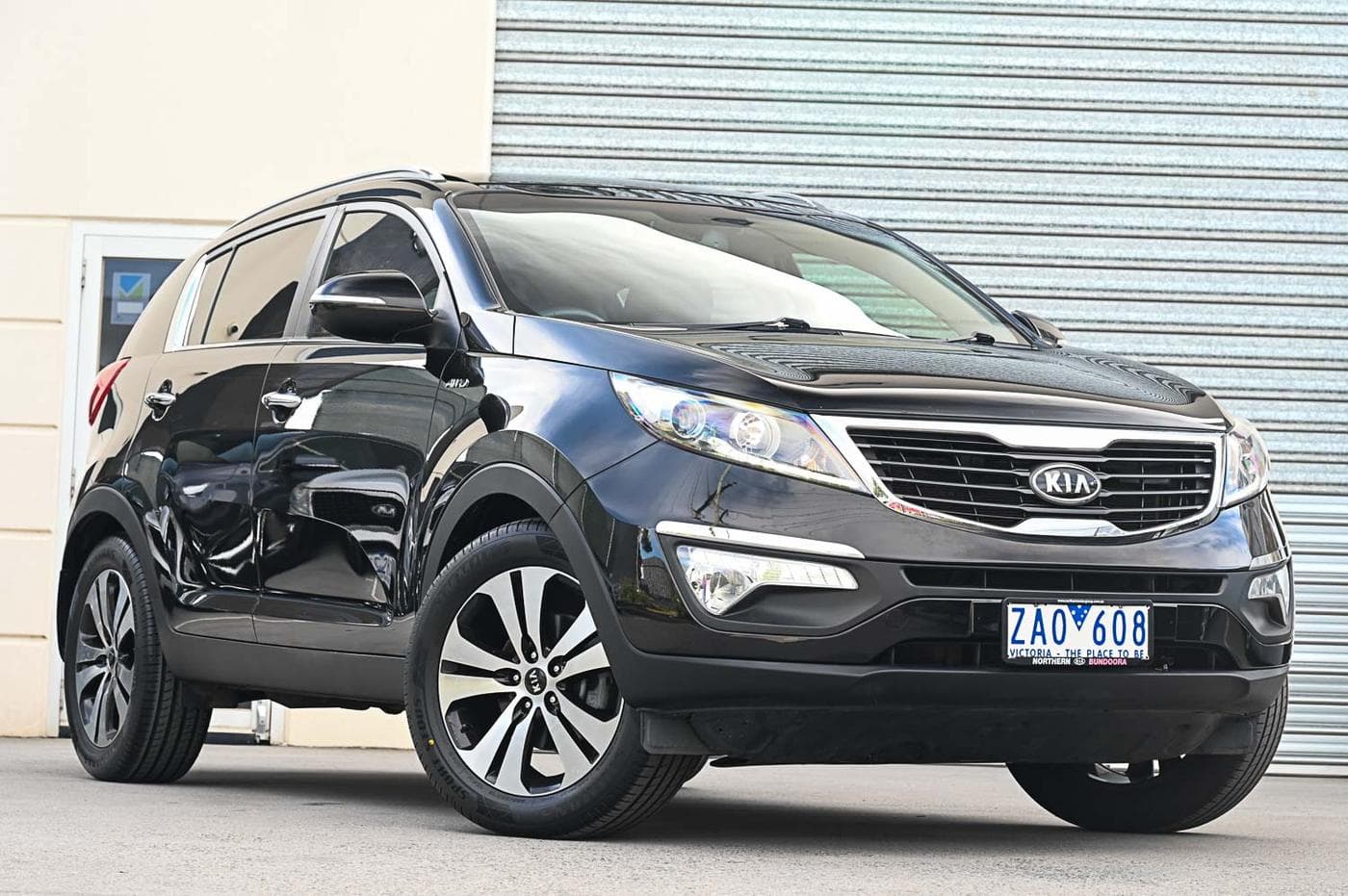 2012 Kia Sportage Platinum AWD in black — front three-quarter view at the Ripper Cars showroom in Springvale
