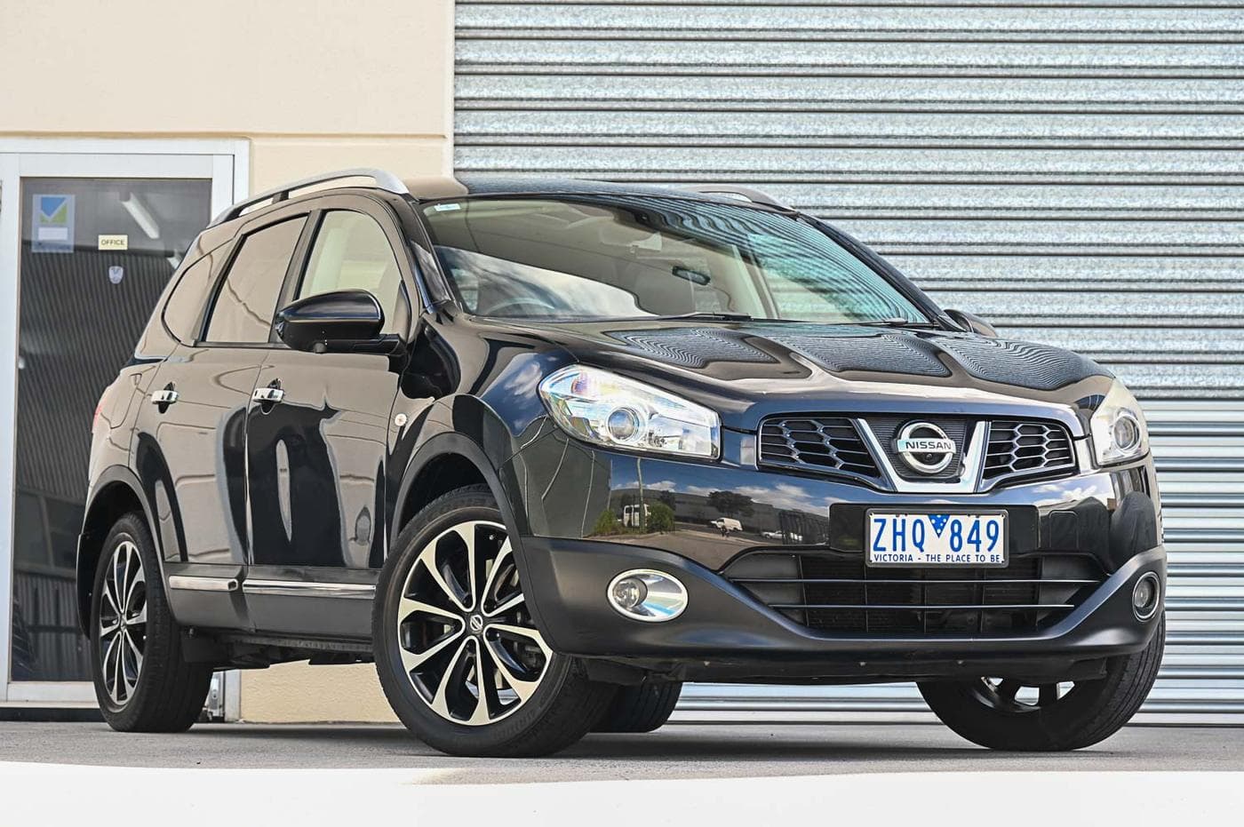 2012 Nissan Dualis +2 Ti-L in black — front three-quarter view at the Ripper Cars showroom in Springvale