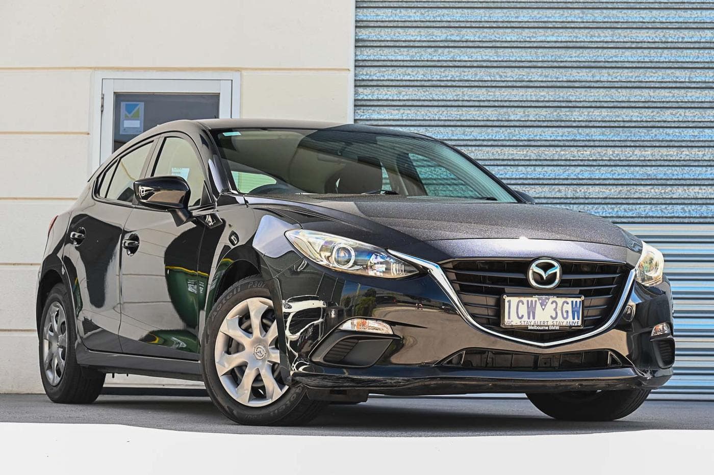 2014 Mazda 3 Neo in black — front three-quarter view at the Ripper Cars showroom in Springvale